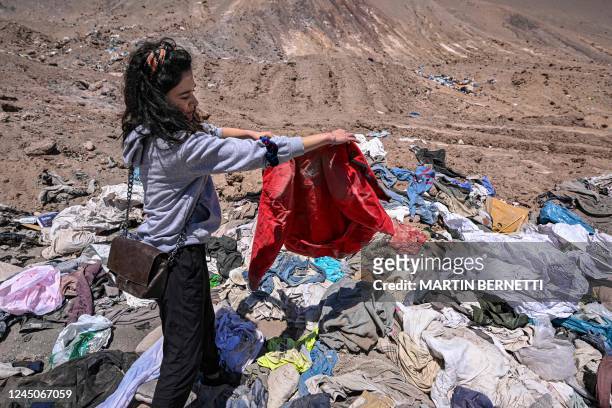 Lawyer Paulin Silva shows clothes dumped in the desert, in La Pampa sector of Alto Hospicio, about 10 km east of the city of Iquique, Chile, on...