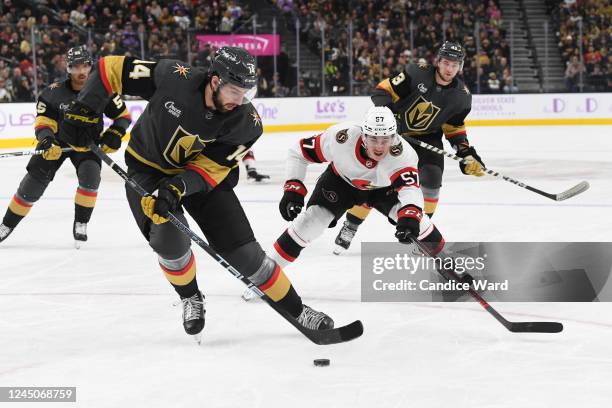 Nicolas Hague of the Vegas Golden Knights skates under pressure from Shane Pinto of the Ottawa Senators in the first period of their game at T-Mobile...