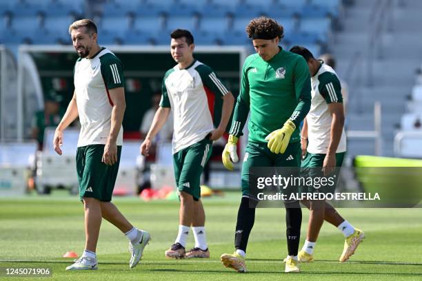 Mexico's goalkeeper Guillermo Ochoa and Mexico's midfielder Hector Herrera take part in a training session at Al Khor SC in Al Khor, north of Doha,...