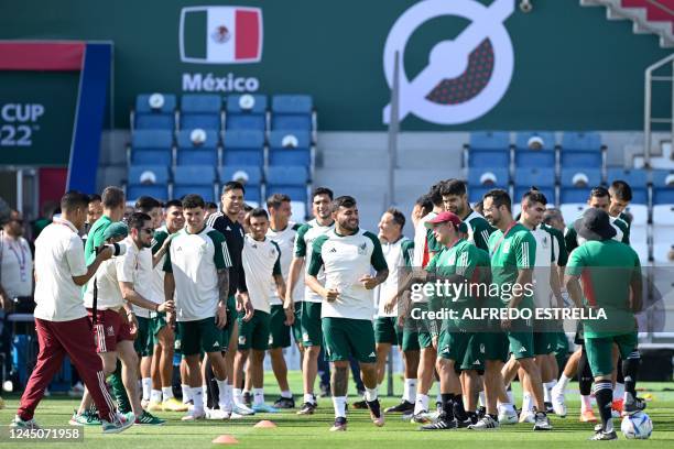 Mexico's players joke with Mexico's forward Alexis Vega during a training session at Al Khor SC in Al Khor, north of Doha, on November 25 on the eve...