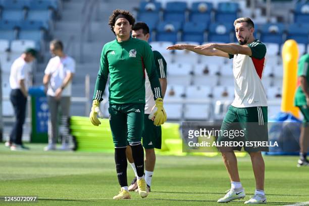 Mexico's goalkeeper Guillermo Ochoa and Mexico's midfielder Hector Herrera take part in a training session at Al Khor SC in Al Khor, north of Doha,...