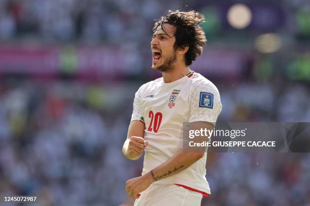 Iran's forward Sardar Azmoun celebrates after Iran's midfielder Ali Gholizadeh scores a goal which was later disallowed after a VAR review due to an...