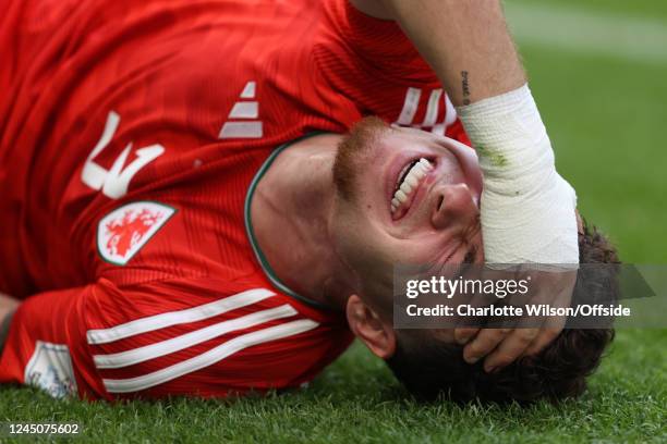 Neco Williams of Wales holds his head as he sustains a painful injury during the FIFA World Cup Qatar 2022 Group B match between Wales and IR Iran at...