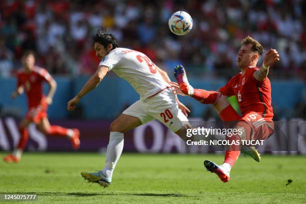 Iran's forward Sardar Azmoun fights for the ball with Wales' defender Joe Rodon during the Qatar 2022 World Cup Group B football match between Wales...