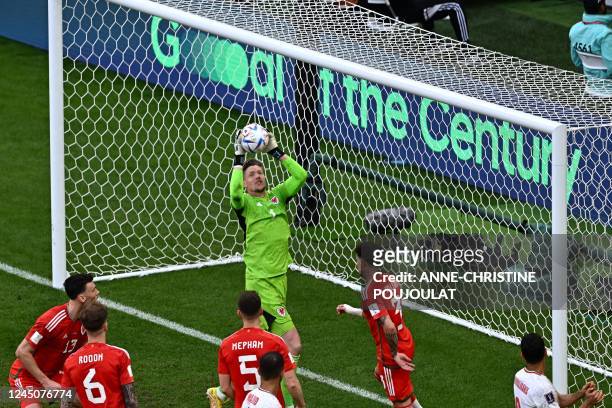 Wales' goalkeeper Wayne Hennessey saves a shot during the Qatar 2022 World Cup Group B football match between Wales and Iran at the Ahmad Bin Ali...