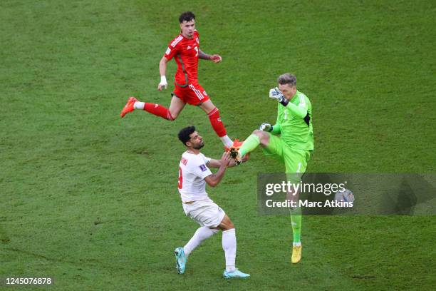 Wayne Hennessey of Wales is shown a red card for this high tackle on Mehdi Taremi of Iran during the FIFA World Cup Qatar 2022 Group B match between...