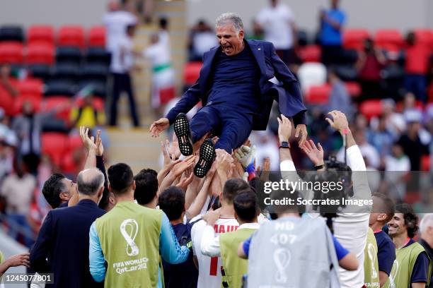 Players of Iran celebrating the victroy with Coach Carlos Queiroz of Iran during the World Cup match between Wales v Iran at the Ahmad Bin Ali...