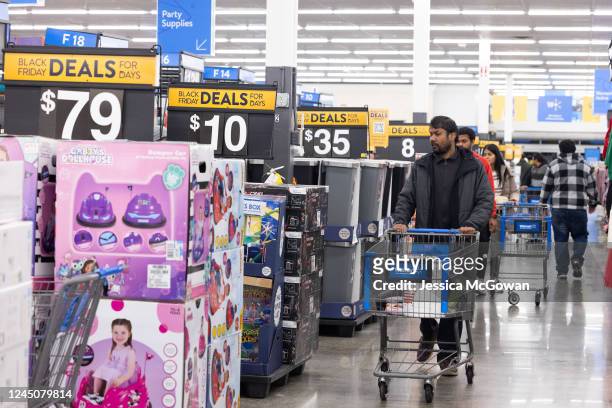 Shoppers walk the aisles of Wal-Mart for Black Friday deals on November 25, 2022 in Dunwoody, Georgia. Walmart opened at 6am on Black Friday for...