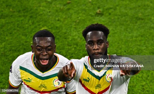 Senegal's forward Boulaye Dia celebrates scoring the opening goal with his teammate Senegal's midfielder Nampalys Mendy during the Qatar 2022 World...