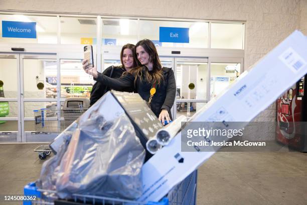 Sisters Janice Dawdy and Karen Carter take a selfie after leaving Wal-Mart with Black Friday deals including a television and cookware on November...