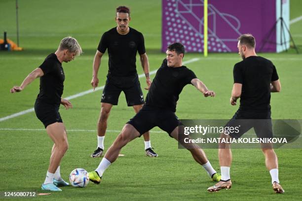 Denmark's defender Jens Stryger Larsen, Denmark's forward Yussuf Poulsen and Denmark's defender Andreas Christensen take part in a training session...