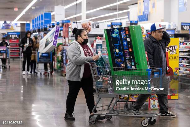 Shoppers pick up televisions and other Black Friday deals at a Wal-Mart on November 25, 2022 in Dunwoody, Georgia. Walmart opened at 6am on Black...