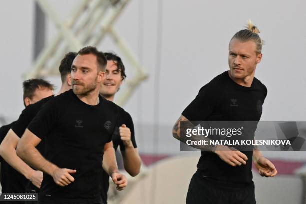Denmark's midfielder Christian Eriksen and Denmark's defender Simon Kjaer take part in a training session at Al Sailiya SC in Doha on November 25 on...