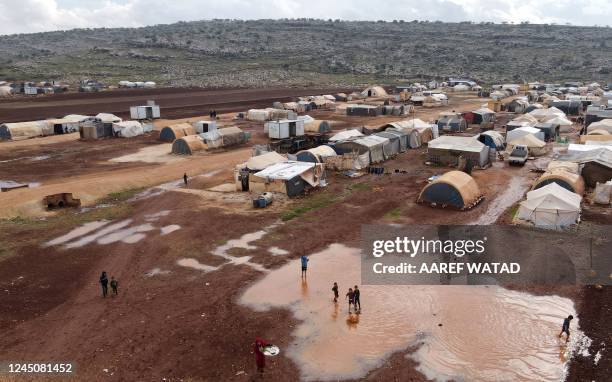 This aerial view shows water puddles after heavy rain, at the Kafr Arouk displacement camp in the rebel-held northern countryside of Syria's Idlib...