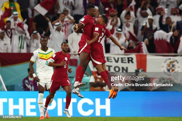 Mohammed Muntari of Qatar celebrates scoring his sides first goal during the FIFA World Cup Qatar 2022 Group A match between Qatar and Senegal at Al...