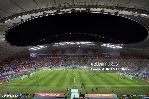 General view shows Netherlands and Ecuador players warming up ahead of Qatar 2022 World Cup Group A football match between the Netherlands and...