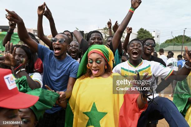 Fans of Senegal national team celebrate their victory at the end of the Qatar 2022 World Cup Group A football match between Qatar and Senegal at a...