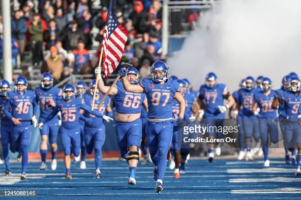 Tight end Kurt Rafdal of the Boise State Broncos leads the team ou to the field prior to the start of first half action against the Utah State Aggies...