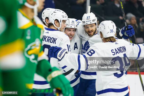 Mitchell Marner of the Toronto Maple Leafs celebrates his goal against the Minnesota Wild with teammates in the first period of the game at Xcel...