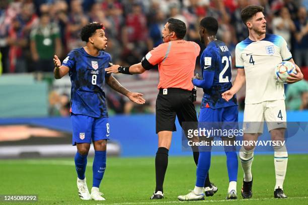 S midfielder Weston McKennie argues with Venezuelan referee Jesus Valenzuela next to USA's forward Timothy Weah and England's midfielder Declan Rice...