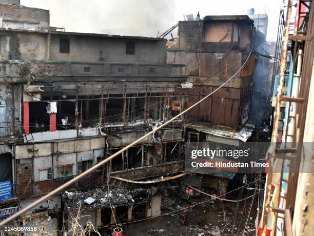 View of burnt and damaged shops after a major fire broke out at Bhagirath palace market, wholesale hub for electrical household goods, on November...