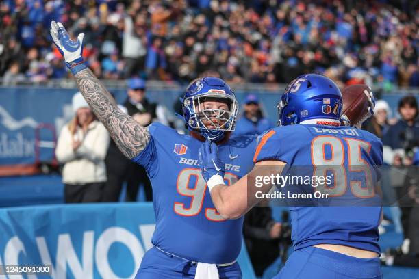 Defensive tackle Scott Matlock of the Boise State Broncos celebrates his touchdown during second half action against the Utah State Aggies at...