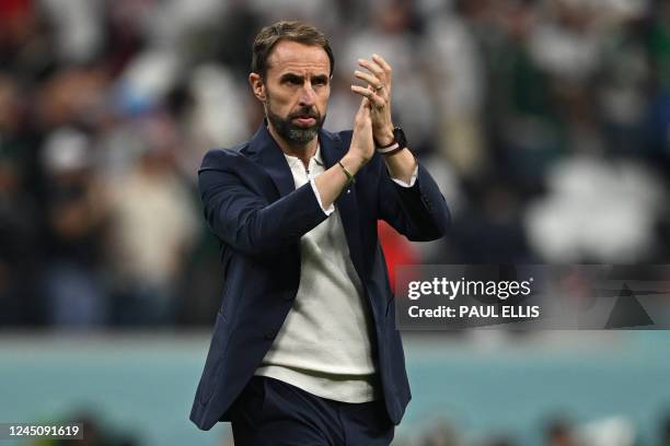 England's coach Gareth Southgate applauds supporters at the end of the Qatar 2022 World Cup Group B football match between England and USA at the...