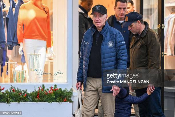 President Joe Biden walks with his son, Hunter Biden, and his grandson, Beau, after having lunch in Nantucket, Massachusetts, on November 25, 2022....