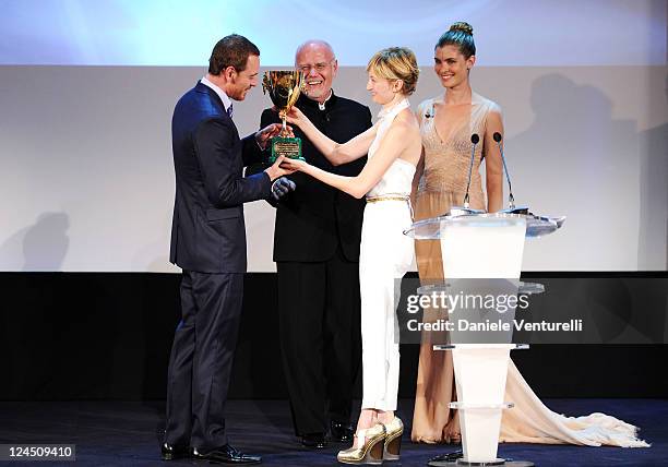 Jury member actress Alba Rohrwacher presents Actor Michael Fassbender of "Shame" the Coppa Volpi for Best Actor as festival director Marco Muller and...