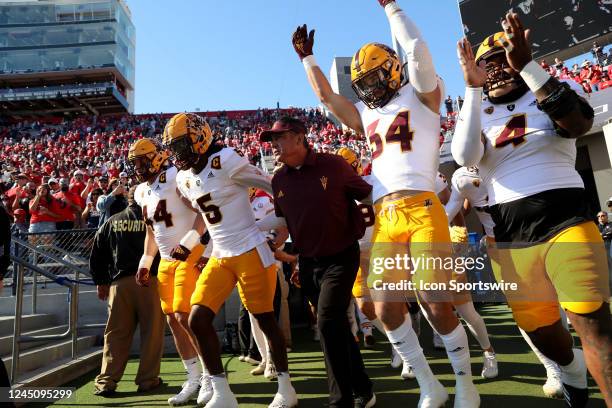 Arizona State Sun Devils interim head coach Shaun Aguano leads the team onto the field prior to the first half a football game between the Arizona...