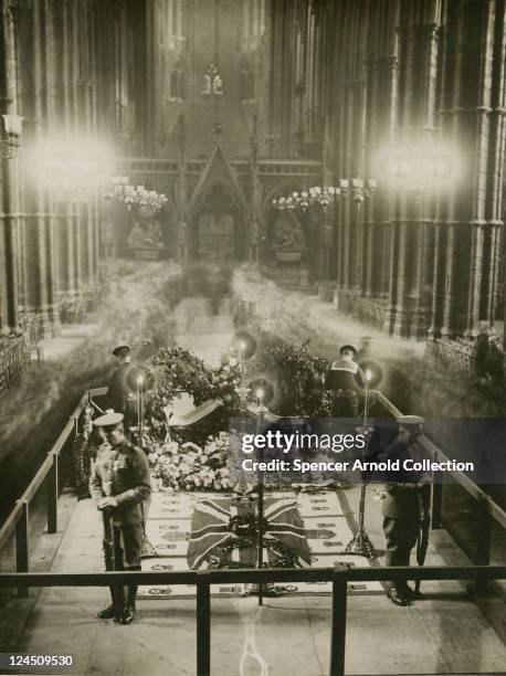 Mourners file past the tomb of The Unknown Warrior, which is being guarded by four British servicemen, at Westminster Abbey, London, 1920.