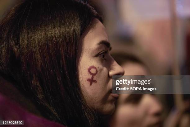 Protester with the Venus symbol on her cheek takes part during the demonstration. Women in many cities of Turkey took part in demonstrations on the...