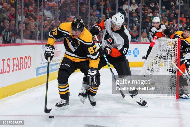Sidney Crosby of the Pittsburgh Penguins controls the puck against Travis Sanheim of the Philadelphia Flyers in the first period at the Wells Fargo...