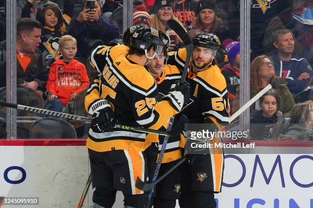 Josh Archibald of the Pittsburgh Penguins celebrates with Ryan Poehling and Kris Letang after scoring a goal against the Philadelphia Flyers in the...