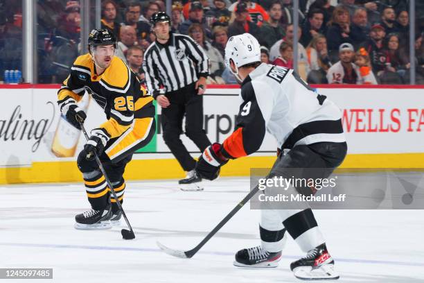 Ryan Poehling of the Pittsburgh Penguins controls the puck against Ivan Provorov of the Philadelphia Flyers in the third period at the Wells Fargo...