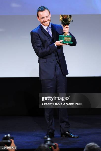 Actor Michael Fassbender of "Shame" accepts the Coppa Volpi for Best Actor during the Closing Ceremony Inside during the 68th Venice International...