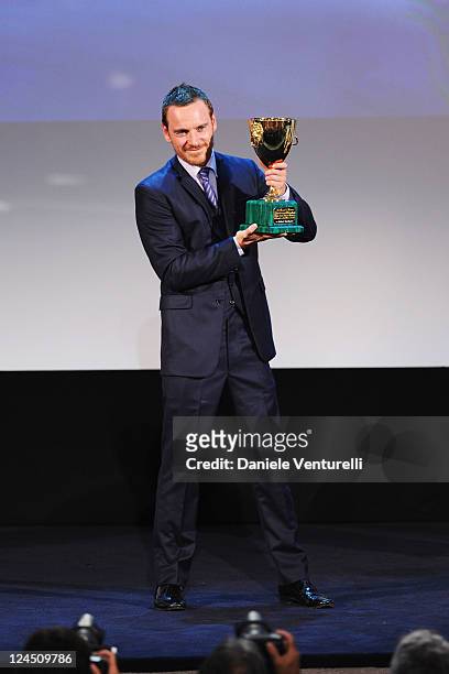 Actor Michael Fassbender of "Shame" accepts the Coppa Volpi for Best Actor during the Closing Ceremony Inside during the 68th Venice International...