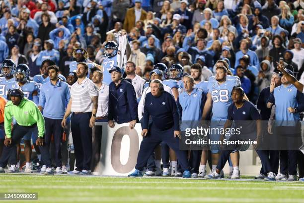 Head Coach Mack Brown of the North Carolina Tar Heels and team watch in anticipation before an attempted field goal during a football game between...