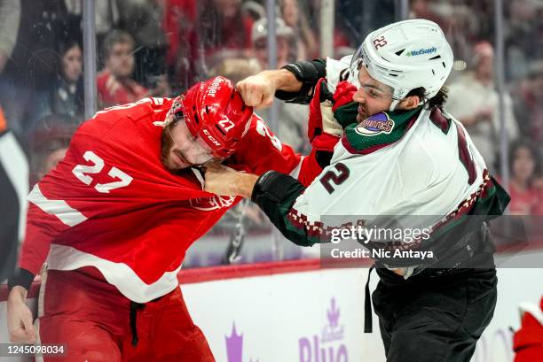 Michael Rasmussen of the Detroit Red Wings and Jack McBain of the Arizona Coyotes fight during the first period at Little Caesars Arena on November...