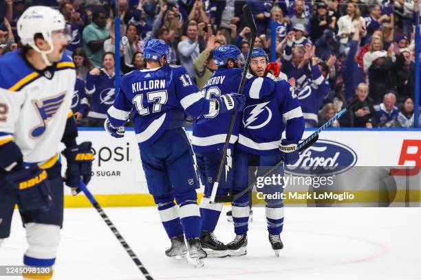 Brayden Point of the Tampa Bay Lightning celebrates a goal with teammates Alex Killorn and Nikita Kucherov against the St Louis Blues during the...