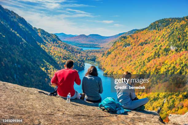 hikers rest in the adirondack mountains new york state usa during autumn - adirondack mountains stock pictures, royalty-free photos & images