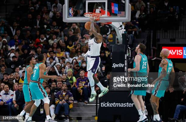 LeBron James of the Los Angeles Lakers dunks past a host of San Antonio Spurs defenders in the second half at AT&T Center on November 25, 2022 in San...