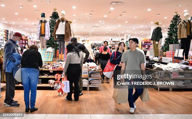 People shop during Black Friday in Santa Anita within the city of Arcadia, California on November 25, 2022. - Inflation hovers over US shopppers this...