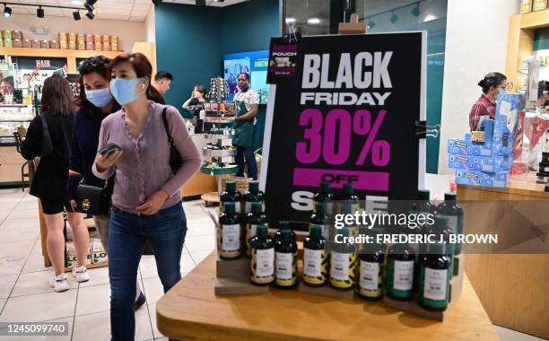 People shop during Black Friday in Santa Anita within the city of Arcadia, California on November 25, 2022. - Inflation hovers over US shopppers this...