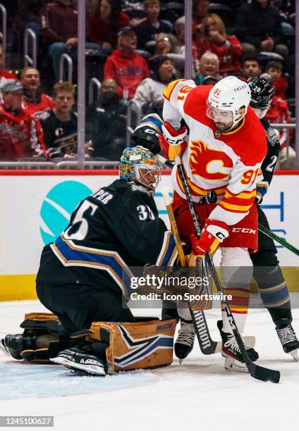 The puck is jammed between \c31\ and Washington Capitals goaltender Darcy Kuemper during a NHL game between the Washington Capitals and the Calgary...