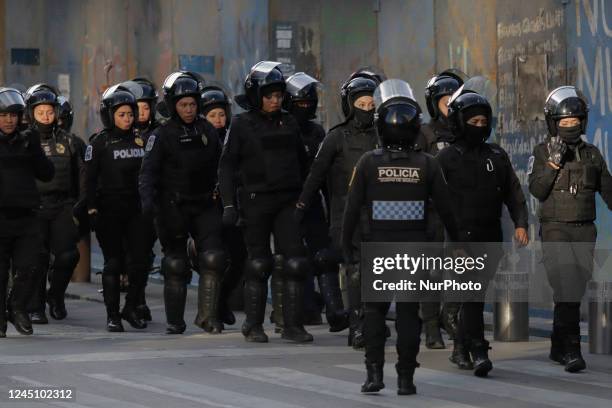 Police guard the streets of the Zócalo in Mexico City during the march of mothers of victims of femicides, relatives of disappeared persons and...