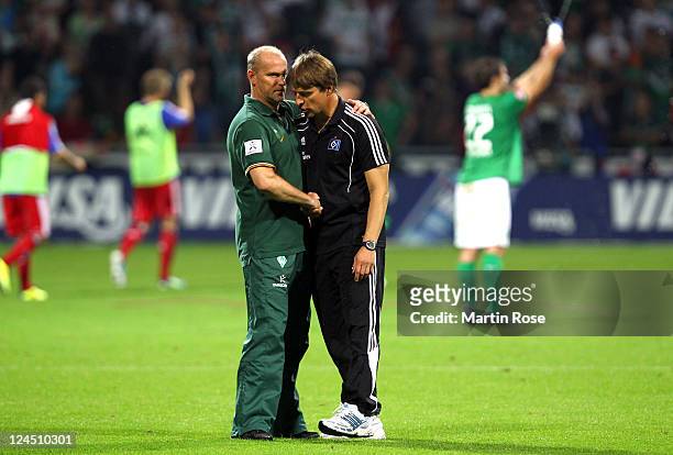 Thomas Schaaf , head coach of Bremen comforts Michael Oenning , head coach of Hamburg after the Bundesliga match between Werder Bremen and Hamburger...