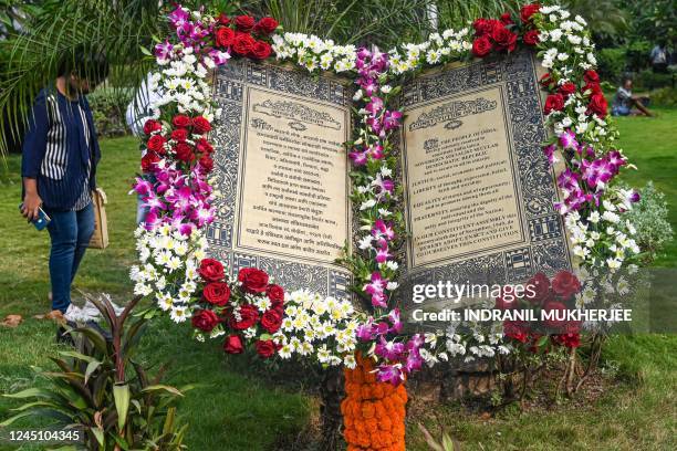 Woman takes off her shoes to pay obeisance to B.R. Ambedkar, chief architect of the Indian constitution at a park displaying an installation of the...