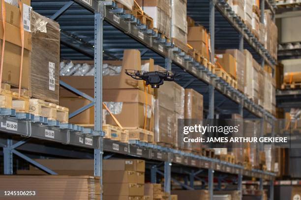 This photograph taken on November 25, 2022 shows an autonomous drone flying in the storage section of Swedish furniture retailer IKEA store of Ghent,...