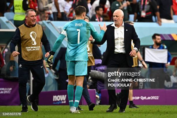 Australia's goalkeeper Mathew Ryan greets Australia's coach Graham Arnold during the Qatar 2022 World Cup Group D football match between Tunisia and...